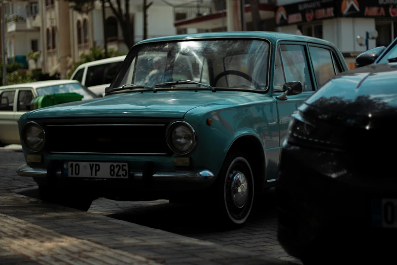 a blue car on the street with other cars