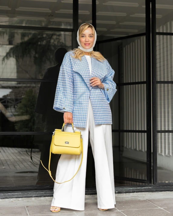 a woman wearing white and blue with a yellow handbag