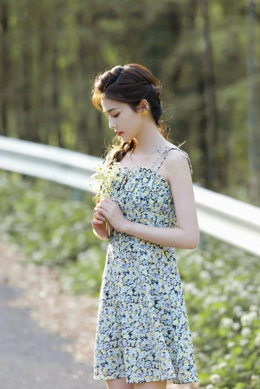 a pretty young lady wearing a floral print dress