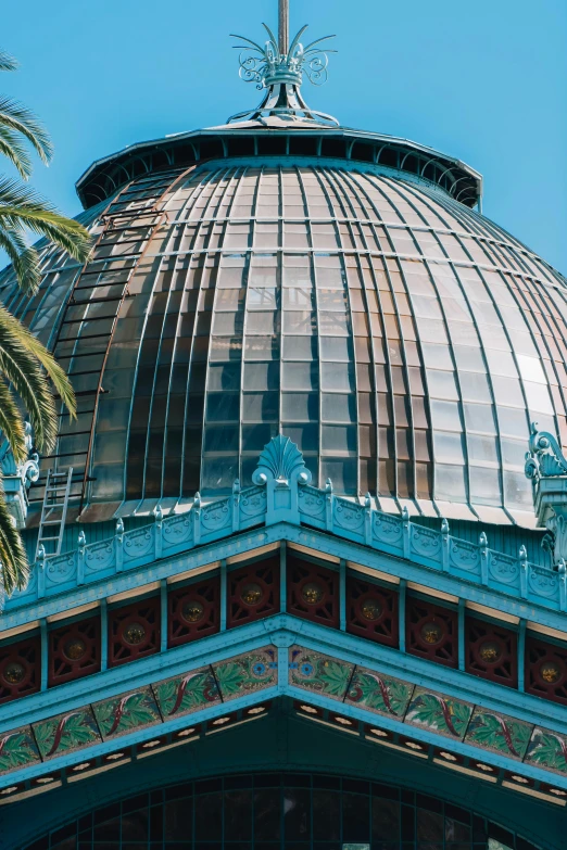 the dome of a building with a weather vein on it