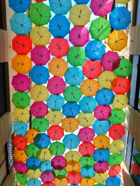 the colorful umbrellas have many drawings written on them