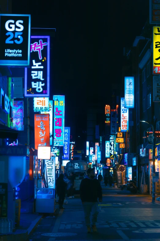 a city street at night with neon signs