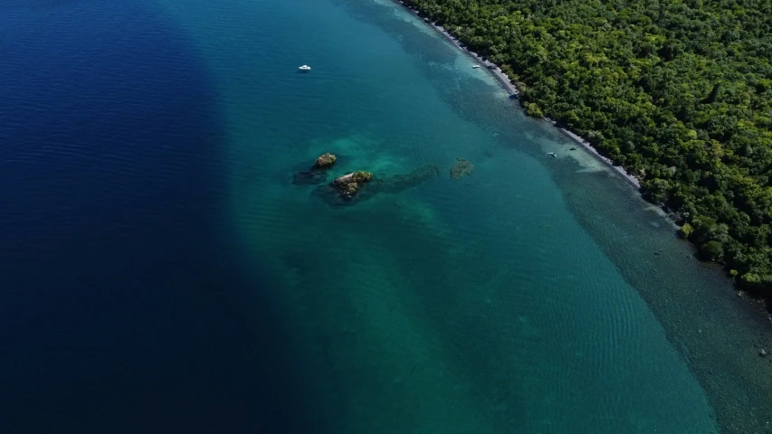 there is a small boat on the water in the ocean