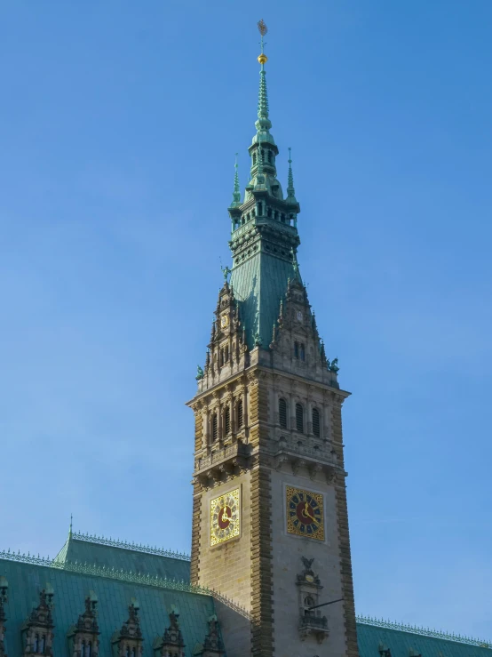 large brown clock tower on top of an old brick building