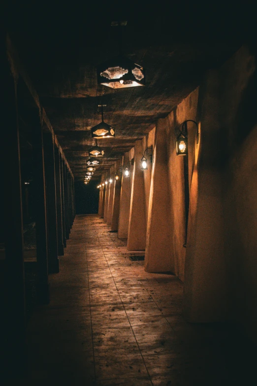 an empty corridor lined with rows of lit umbrellas
