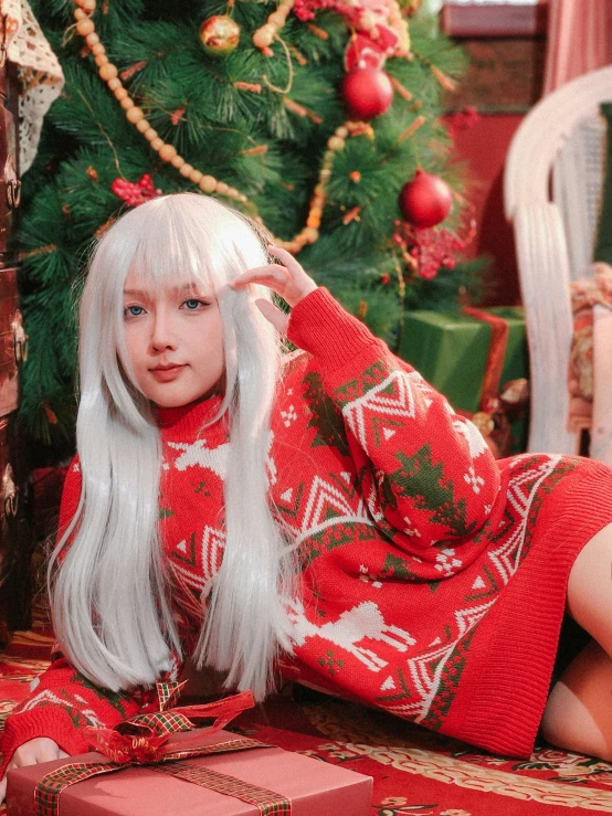 a lady with white hair dressed in christmas clothing