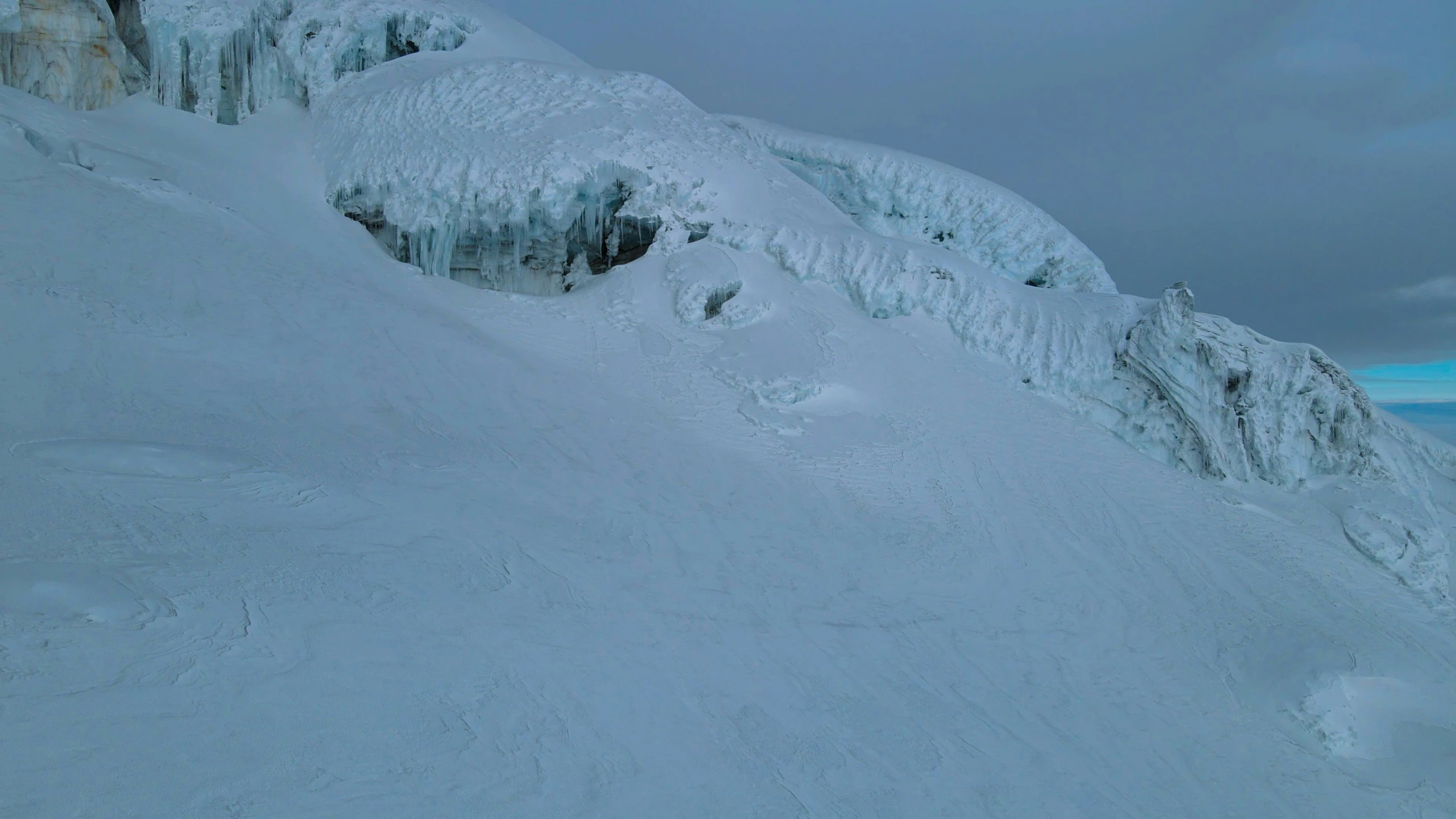 a man riding skis down the side of a snow covered slope