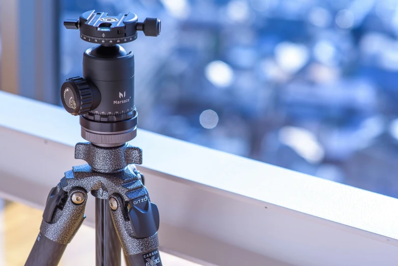 a tripod with a camera inside it, on a table