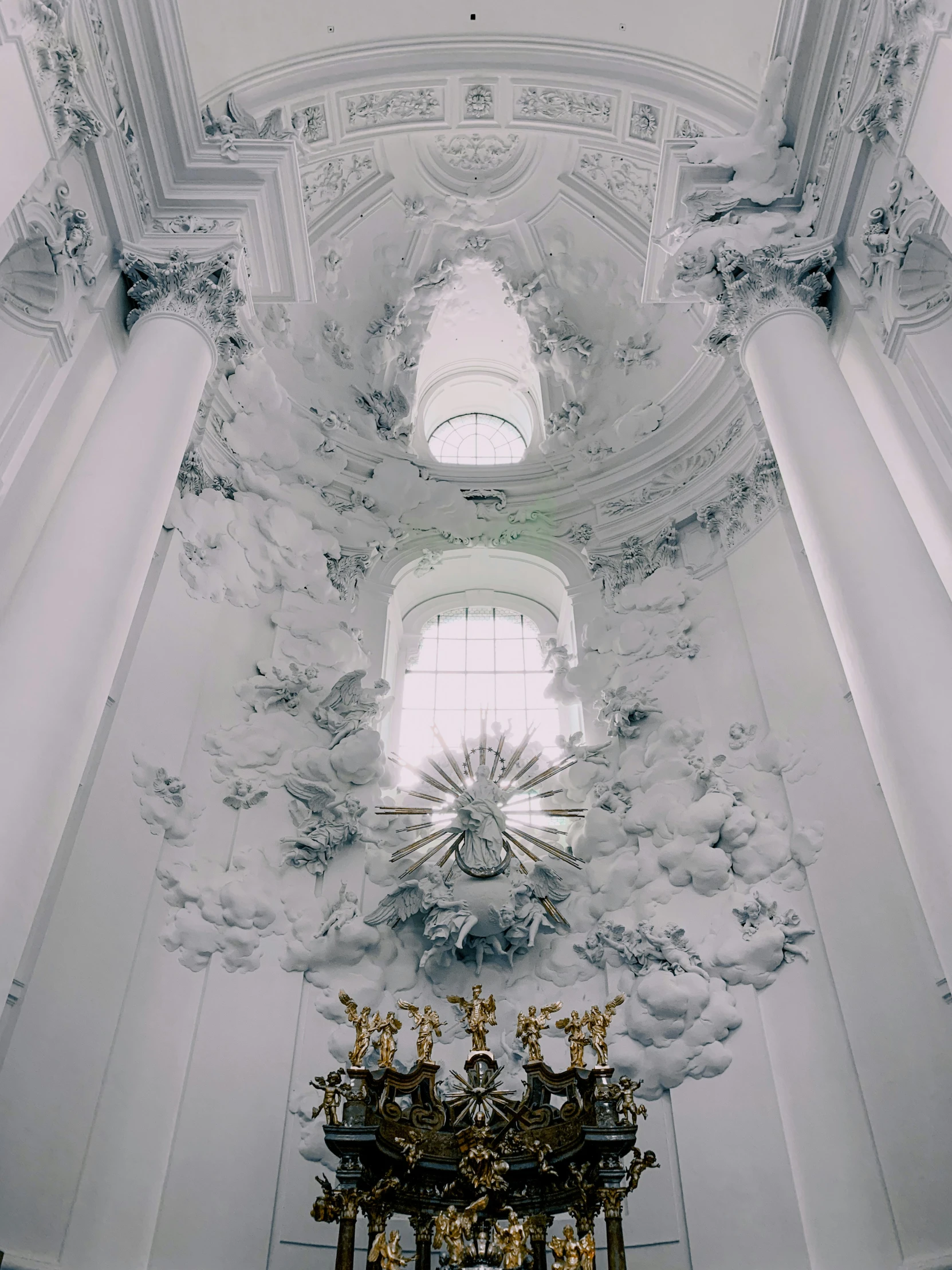 an intricate ceiling in a church with a very large window