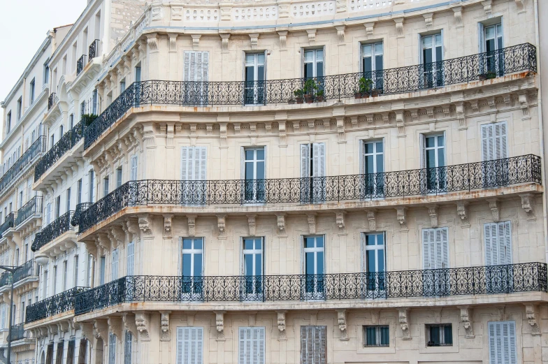 a tall building with many balconies and a clock