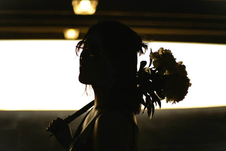 the woman is holding flowers and she is wearing sunglasses