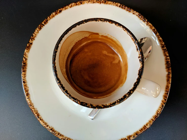 there is an empty cup of coffee on the plate