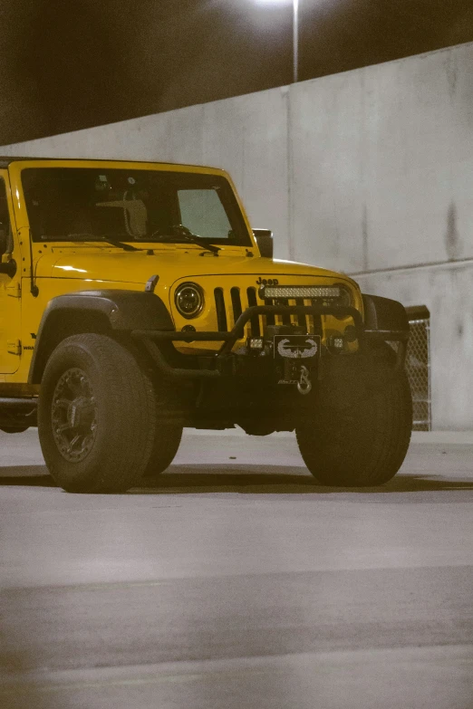 a big yellow vehicle parked in a parking garage