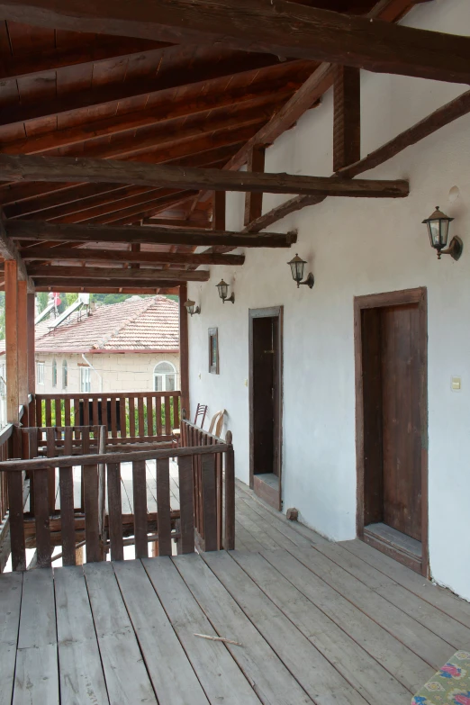 the porch is covered with a set of brown doors