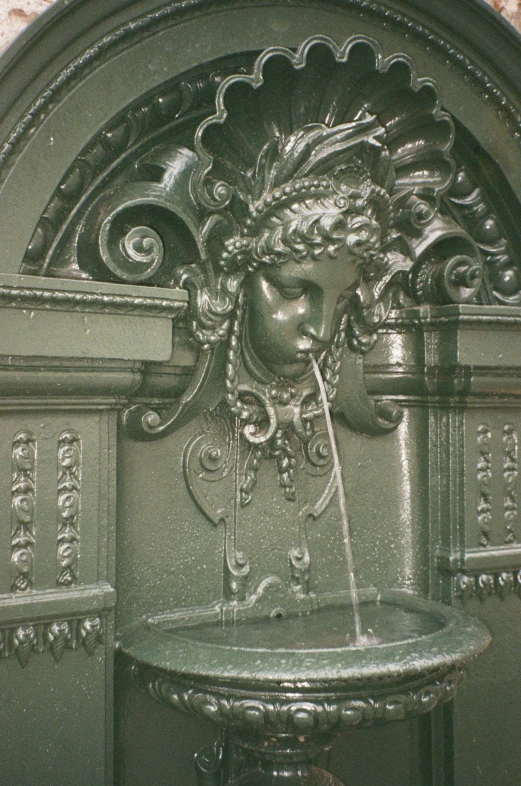 a fountain has a statue of a woman with a hair
