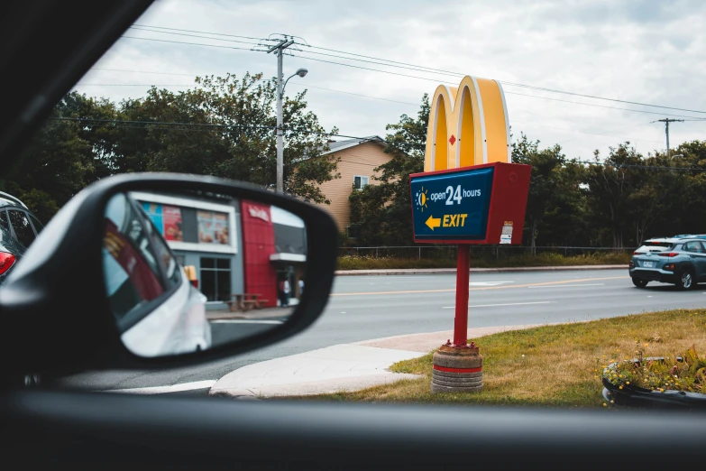 this is a mcdonald's burger sign and cars