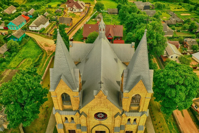 an aerial s of a church with green and yellow trees