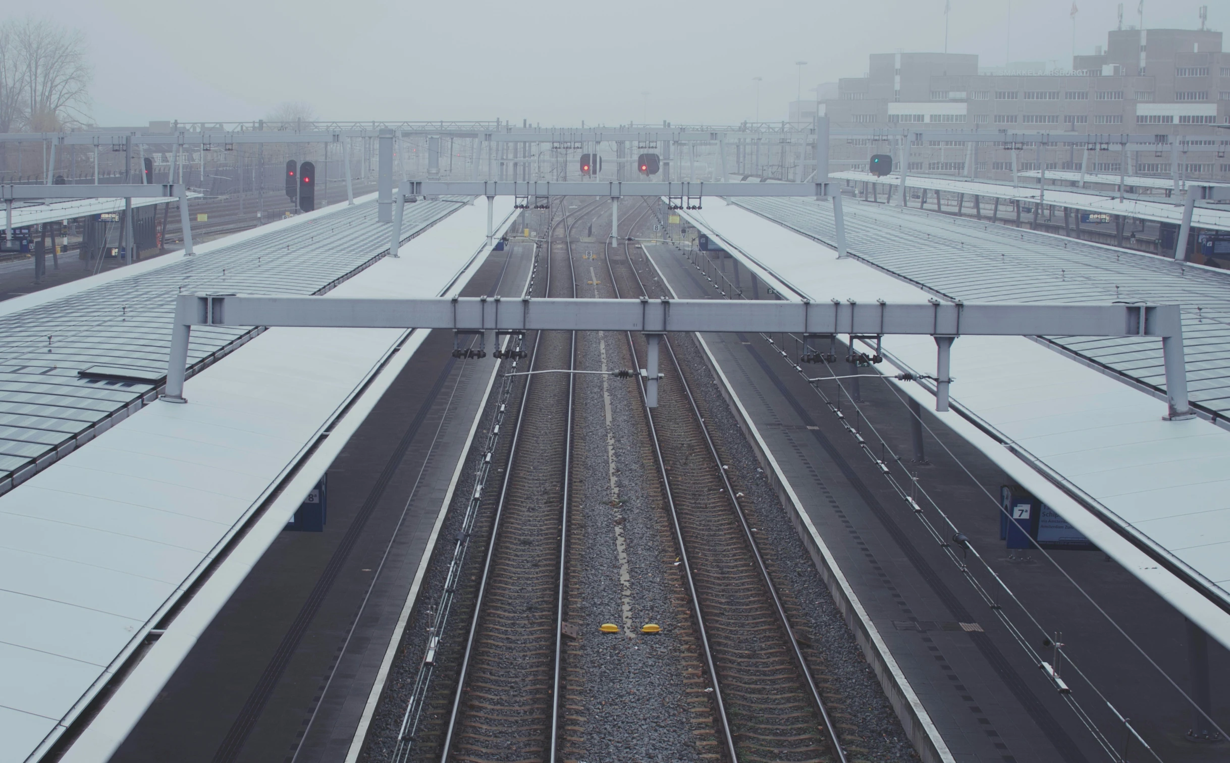 an overhead view of trains on tracks in a train yard