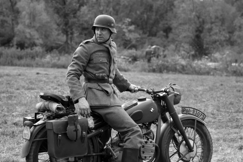 a man in uniform sits on a motorcycle