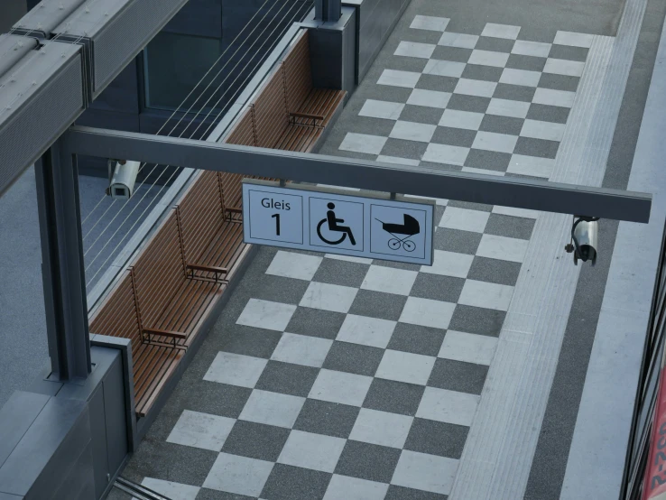 a black and white checkered walkway with a handicapped sign