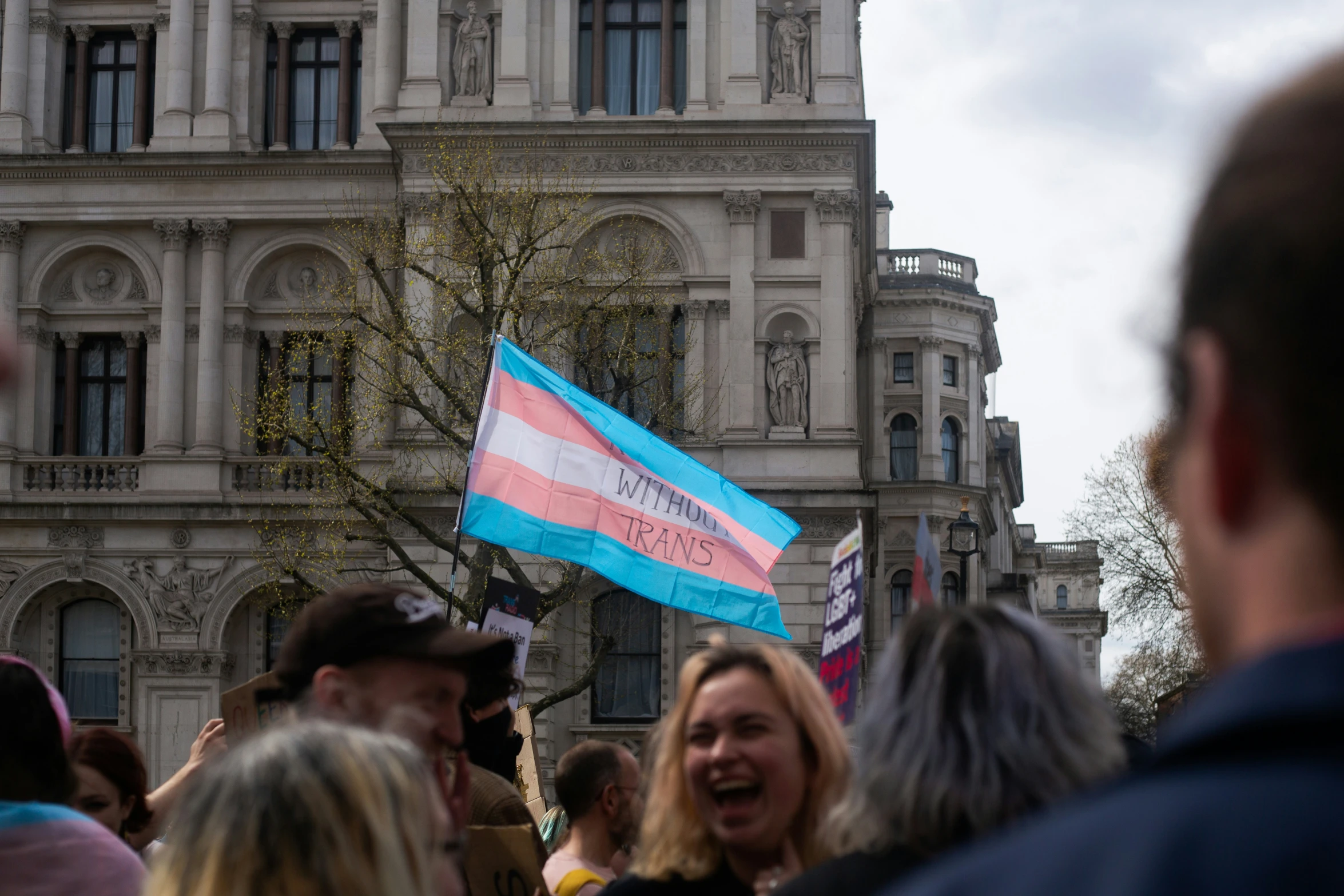 a flag in a crowd, with people standing around