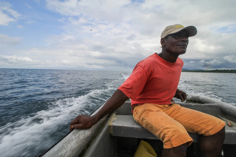 a man is sitting on a boat while looking back