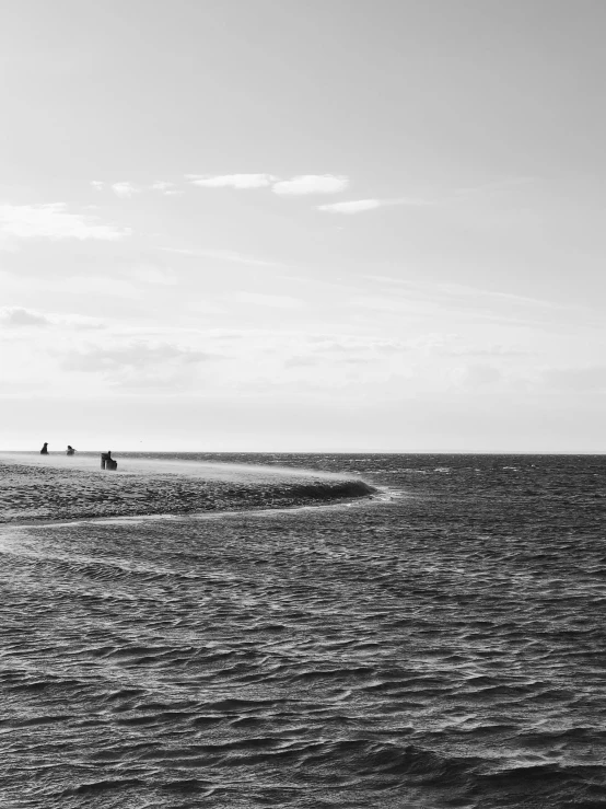 a black and white po of a beach with people on it