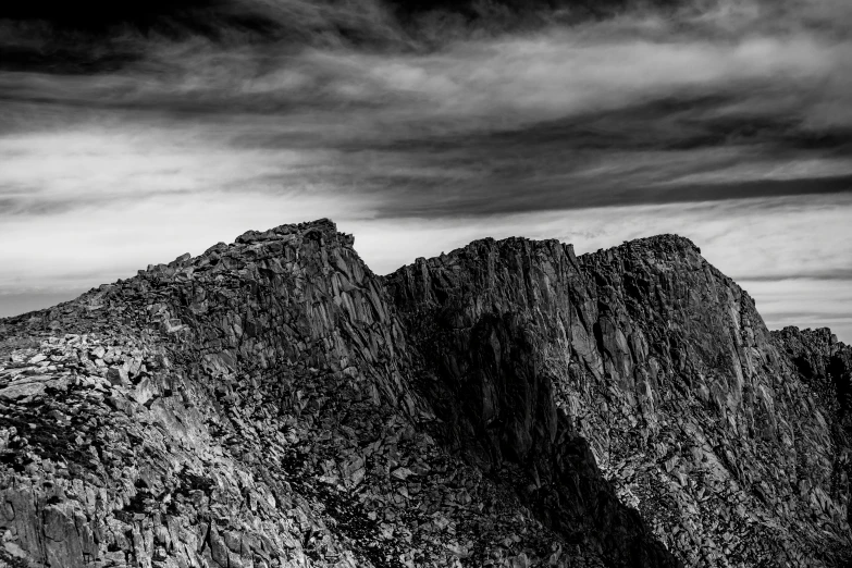 the mountains are covered in dark grey clouds