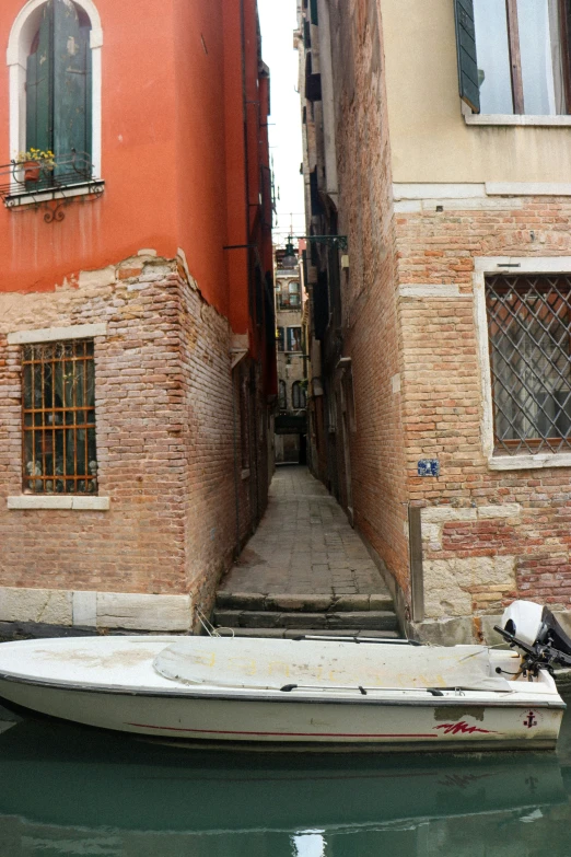 a boat parked next to an old building