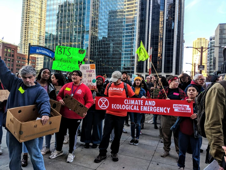 group of people standing in the street holding up signs