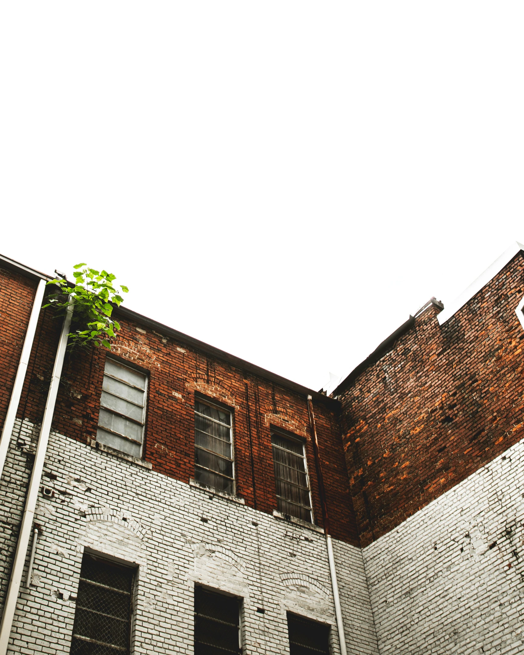 a red stop sign is attached to a brick building