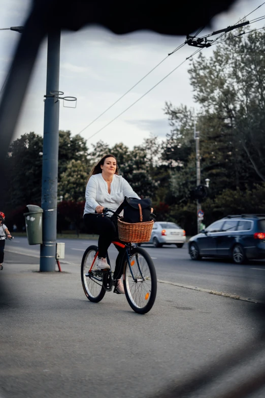 a woman riding on a bike through an intersection