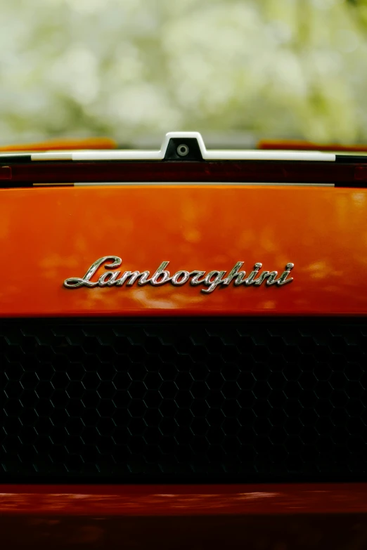 an orange colored car with the word lamberato on it