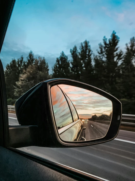 this car has a reflection of the sunset