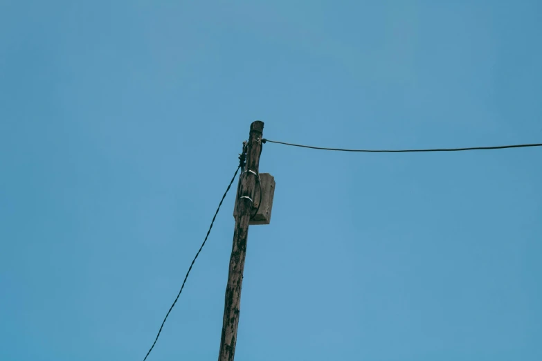 an electric pole with a traffic light hanging off it