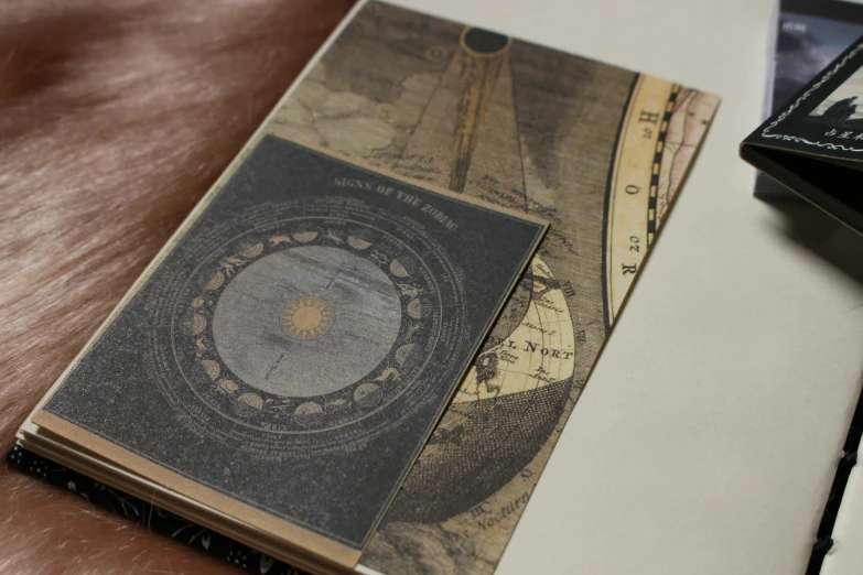 a brown table topped with a book and pen