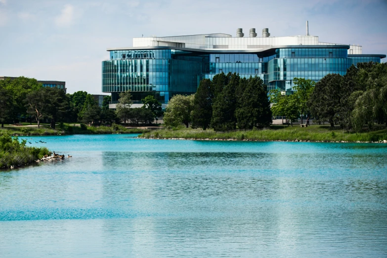 blue river with boat in the middle and building beside it