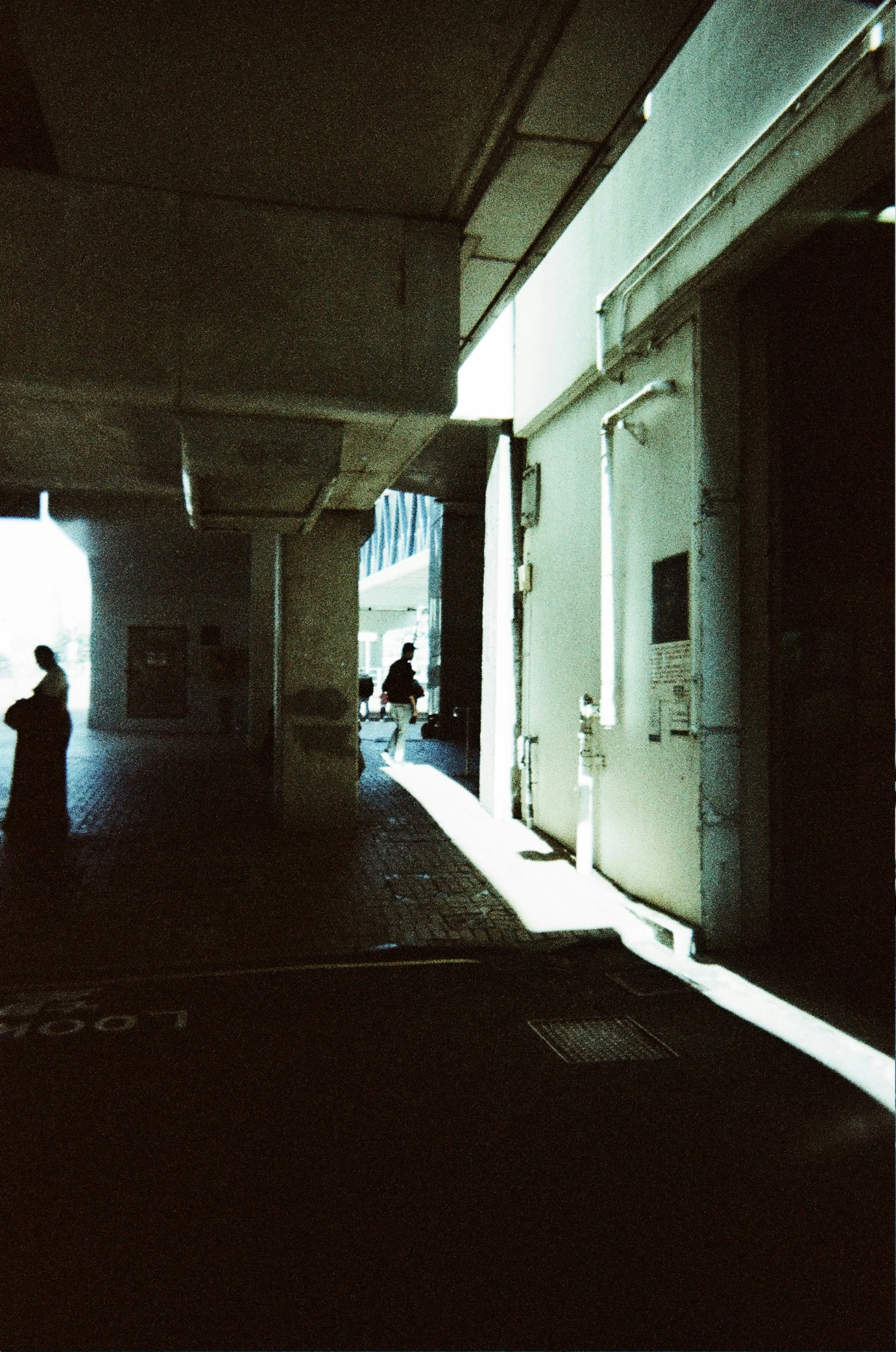 silhouette of two people standing in an open hallway