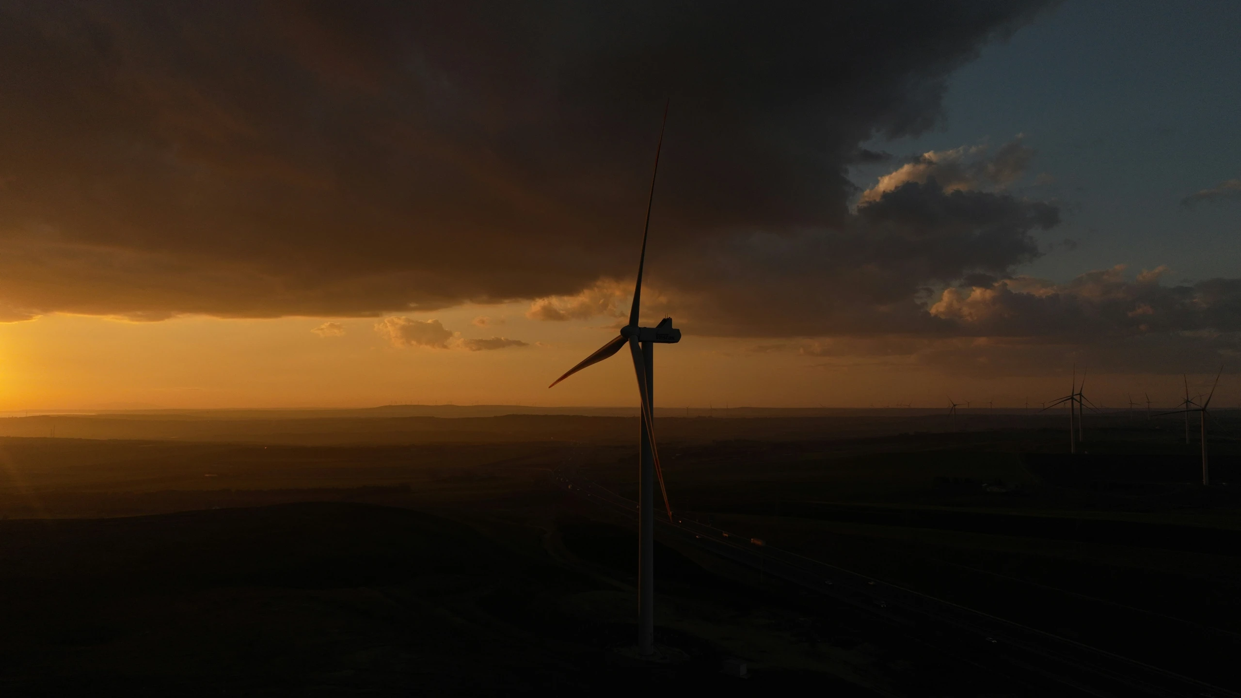 the silhouette of windmills as it's sun set