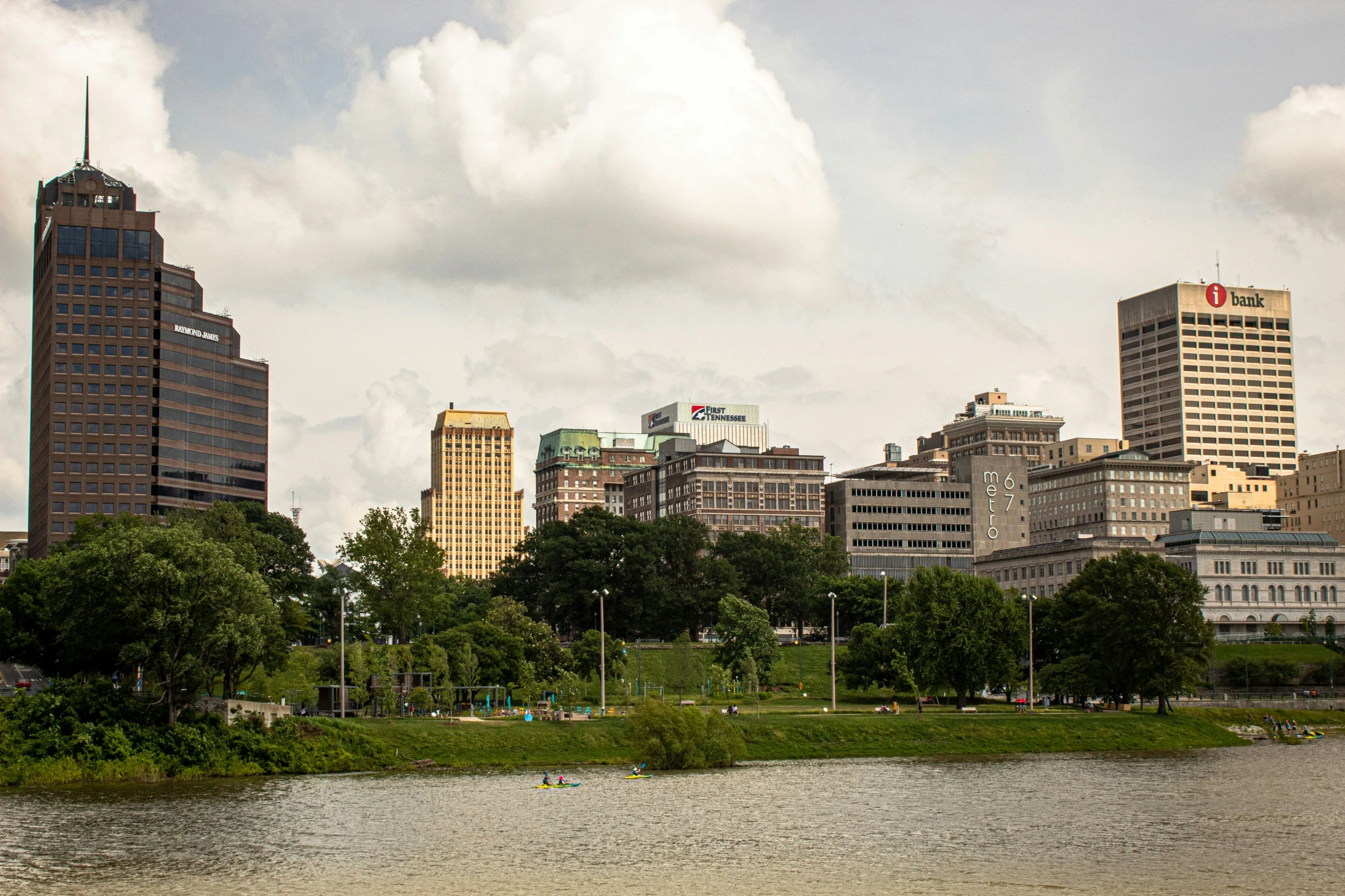 a city is next to a river with buildings in the distance