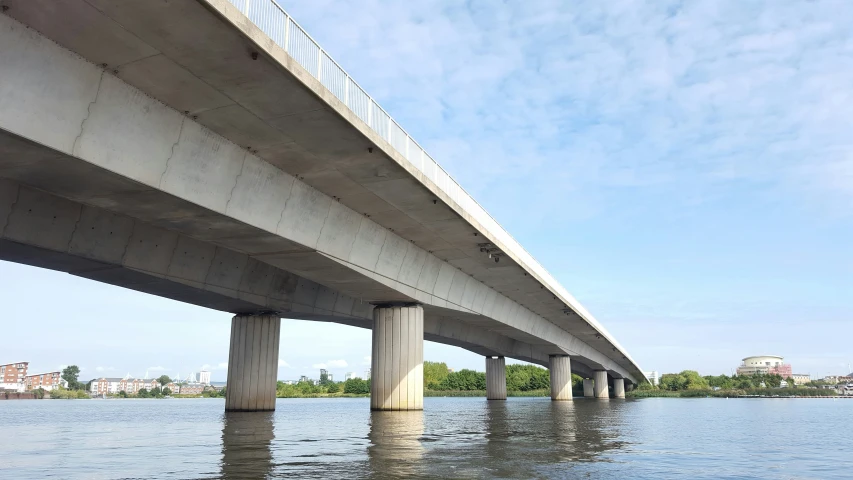 two large bridges over the water and buildings in the background