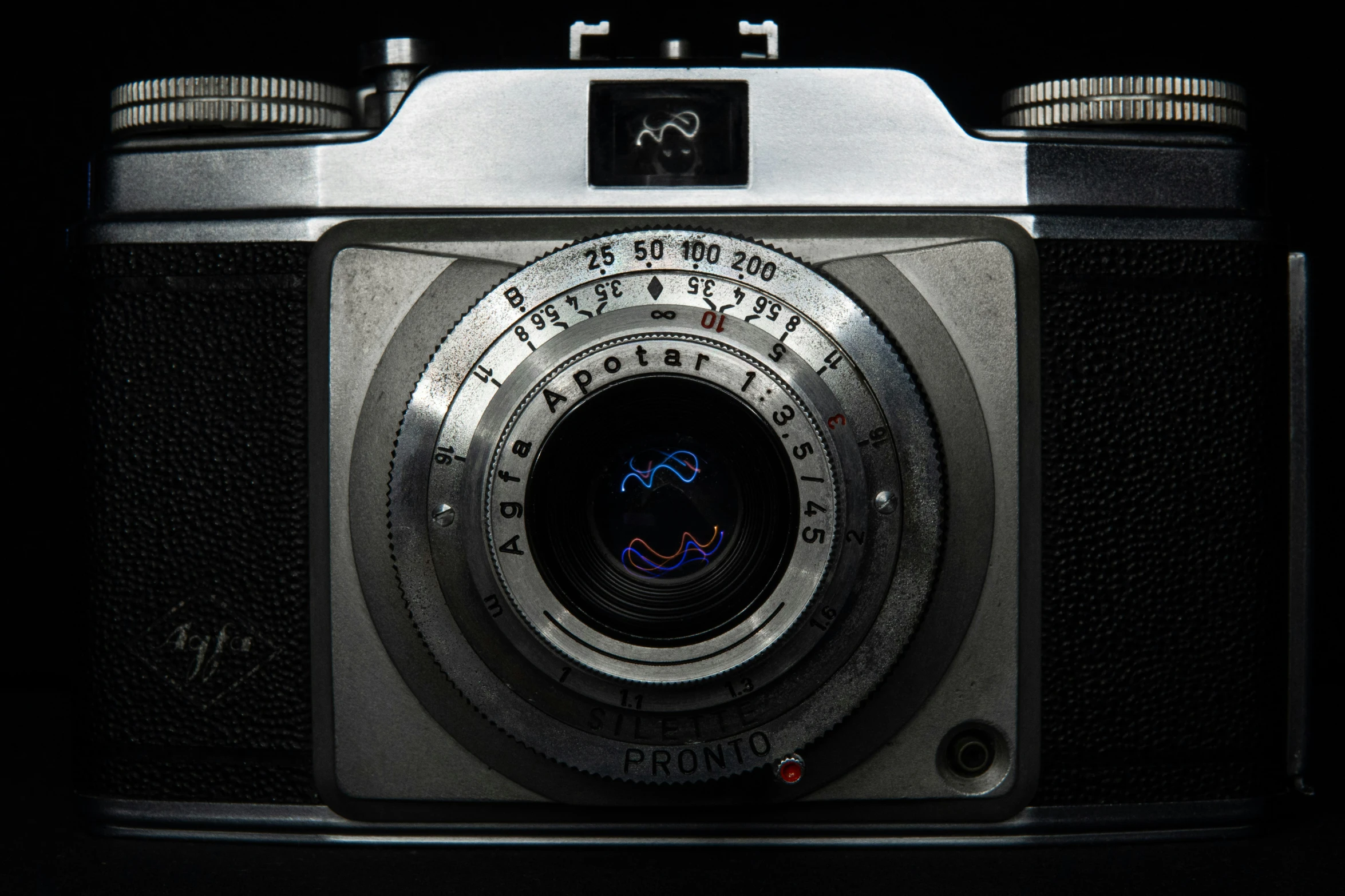 a camera is shown, black with silver accents