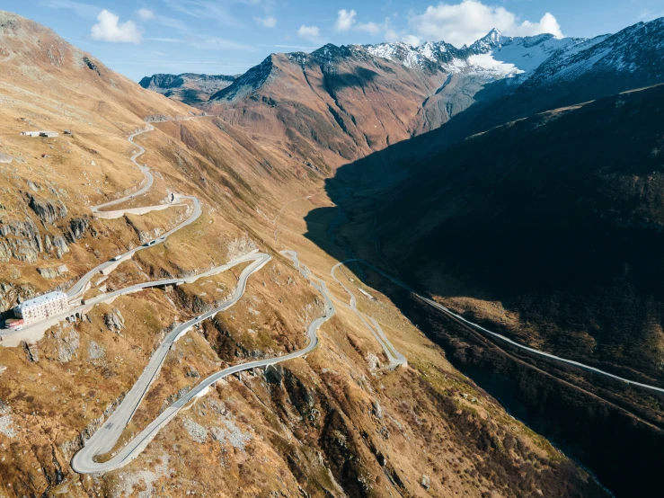 a winding road and mountain pass, leading into the distance