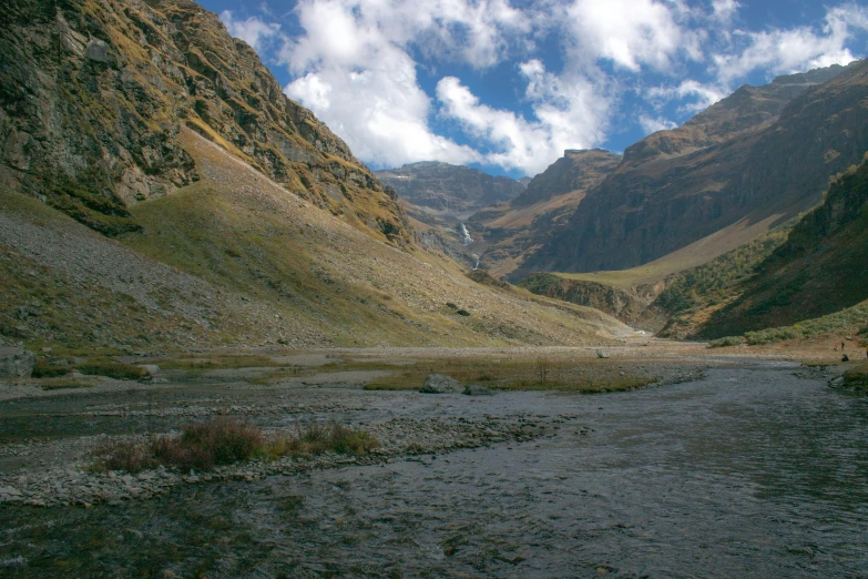 mountains that have dirt and grass on them