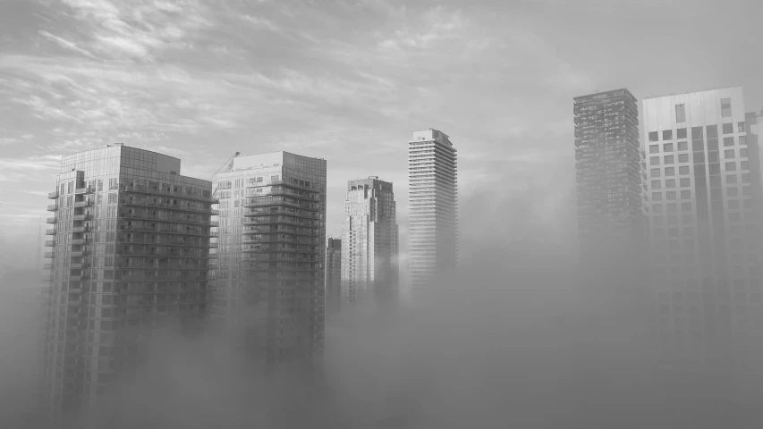 buildings covered in fog and clouds with large spires