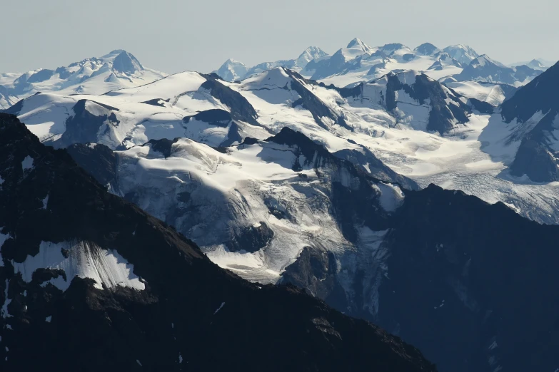 the snow covered mountains with a blue sky