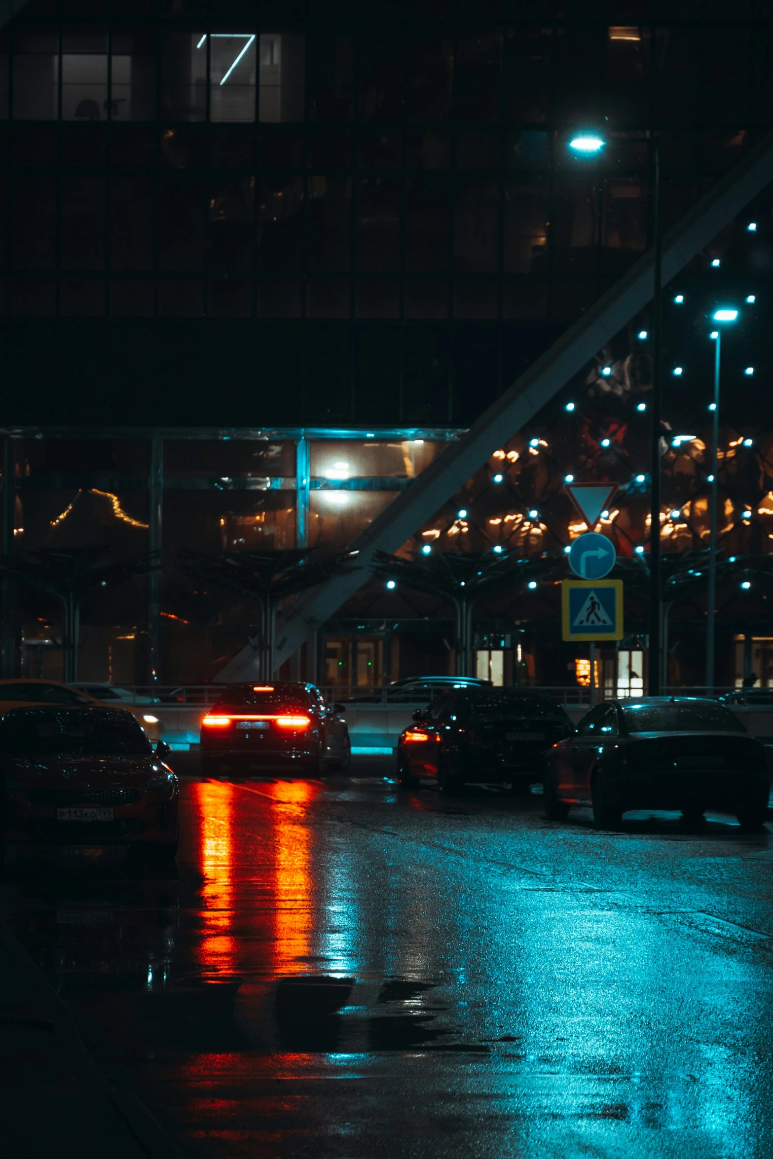 a traffic light in a city at night with rain on the ground