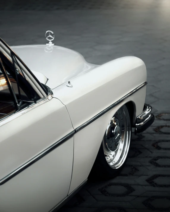 a very old white car is parked on the street