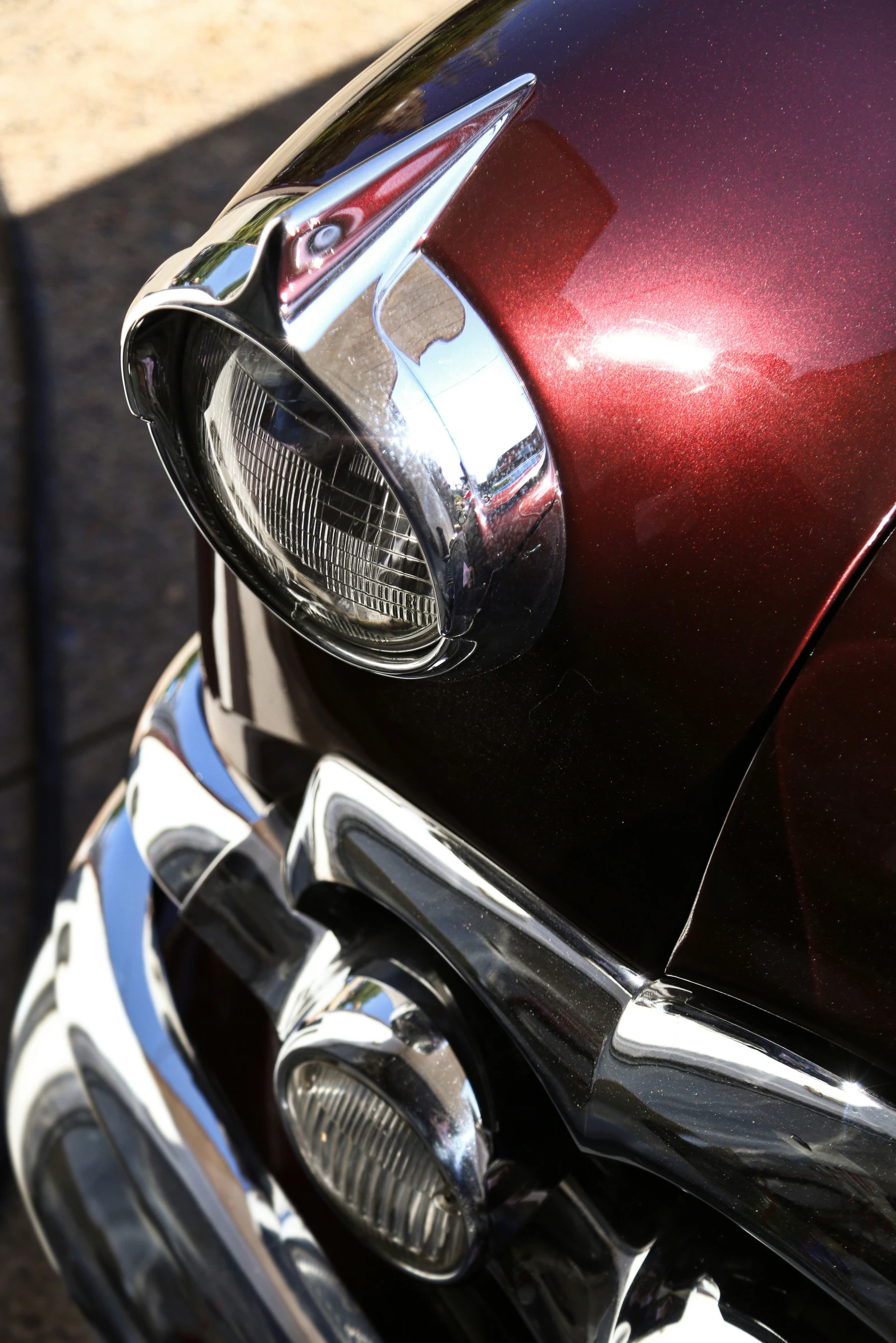 closeup of a shiny shiny red car headlight
