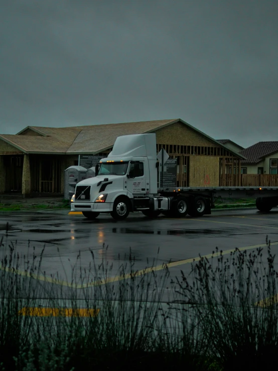 a semi - truck is parked in a parking lot